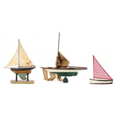 three-vintage-wooden-sailboats