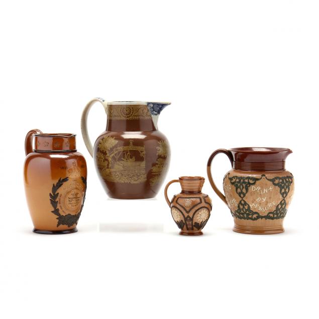 group-of-four-english-stoneware-pitchers