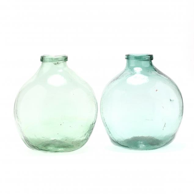two-large-green-glass-demijohn-bottles