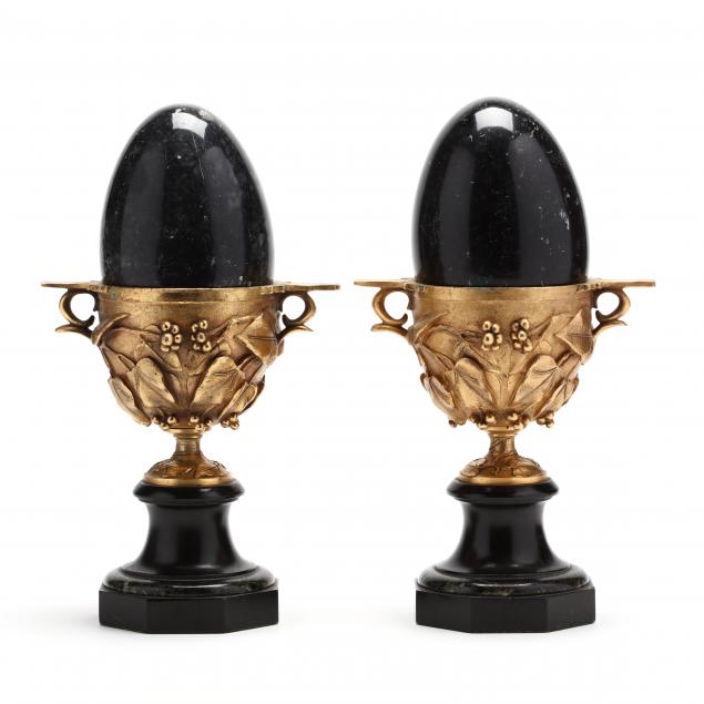 pair-of-black-marble-eggs-set-in-gilt-chalice-urns