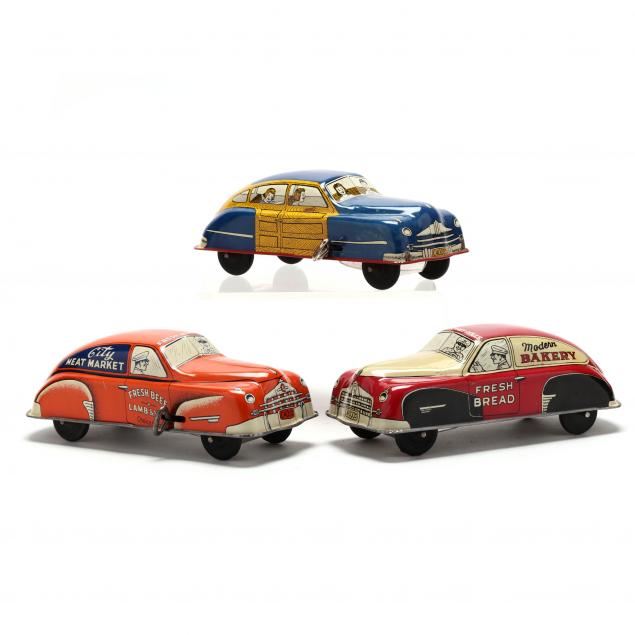 two-courtland-tin-litho-delivery-vehicles-and-a-woody