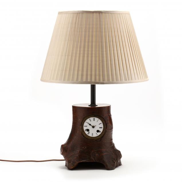a-carved-stump-form-pendulum-clock-as-table-lamp