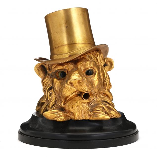 a-gilt-bronze-inkwell-in-the-form-of-a-lion-with-a-top-hat