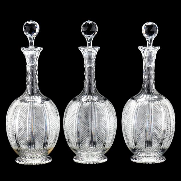 a-set-of-three-very-fine-cut-glass-decanters