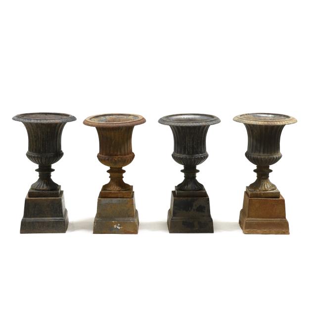 four-matching-classical-style-cast-iron-urns-on-stands