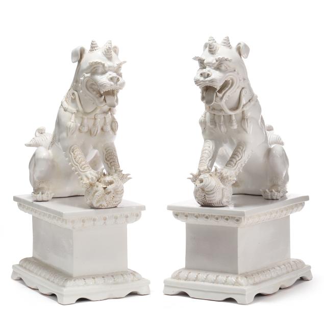 a-palatial-pair-of-italian-white-glazed-foo-dogs-on-plinths