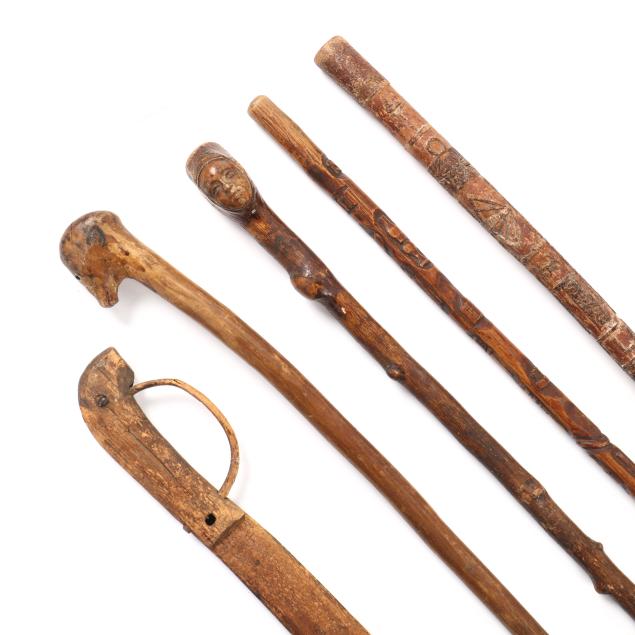 four-folk-art-carved-wood-canes-and-a-sword