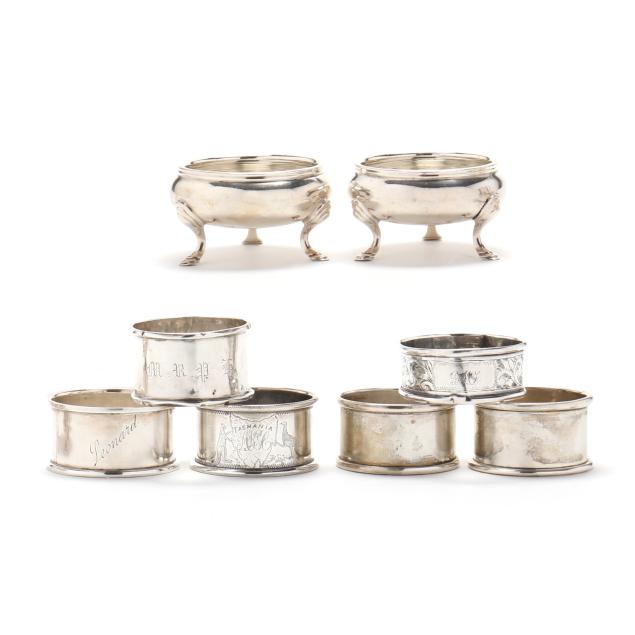 a-pair-of-english-silver-master-salt-cellars-and-group-of-assorted-english-silver-napkin-rings