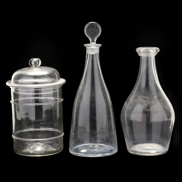 two-antique-glass-decanters-and-lidded-jar