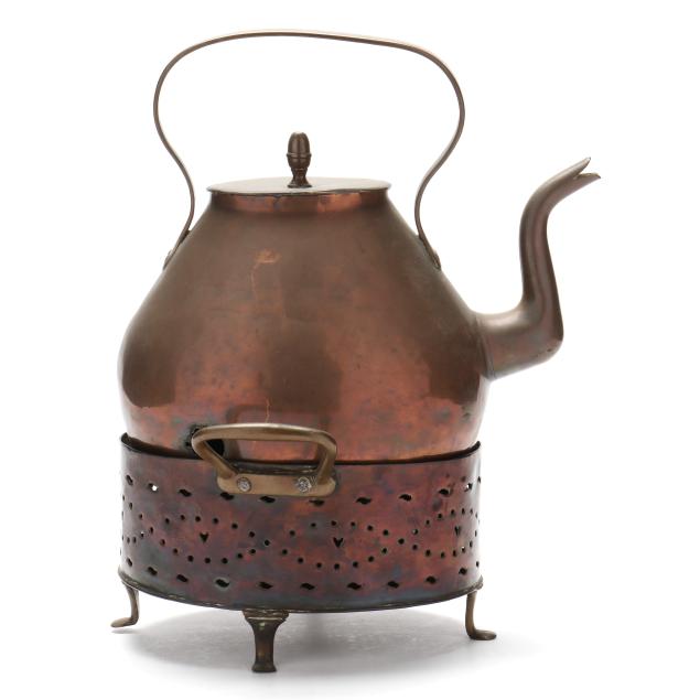 an-antique-copper-kettle-on-stand