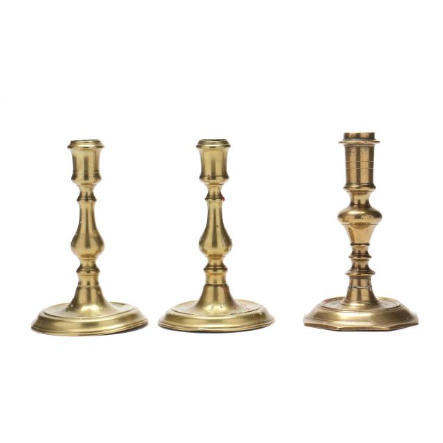 three-english-18th-century-brass-candlesticks