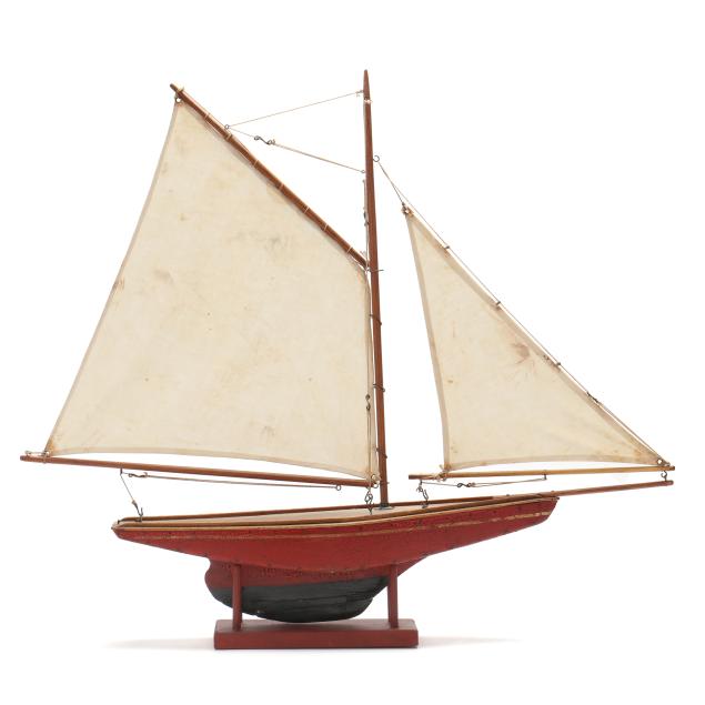 a-vintage-pond-sailboat-on-stand