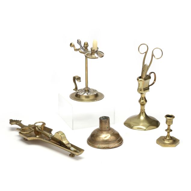 a-collection-of-early-brass-candlestick-accoutrements